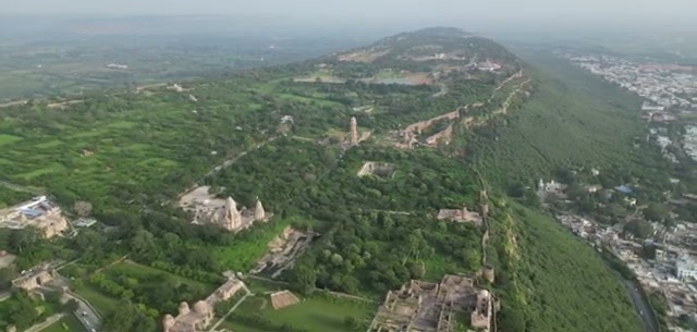 Aerial view of the lush green fort complex on its hilltop