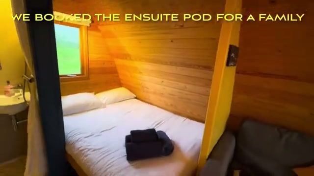 The ensuite pod’s wood-clad bedroom with double bed, bathroom visible through the doorway