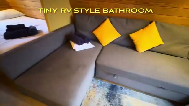 The pod’s sitting area with couch and yellow cushions