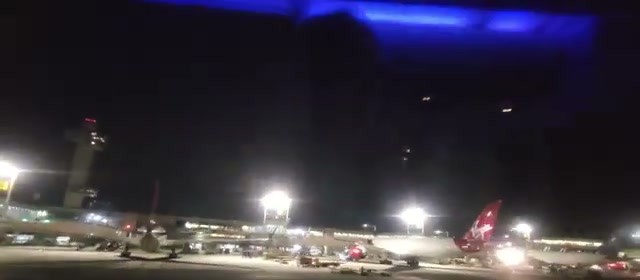 Taxiing past Terminal 4 at night, on-time departure