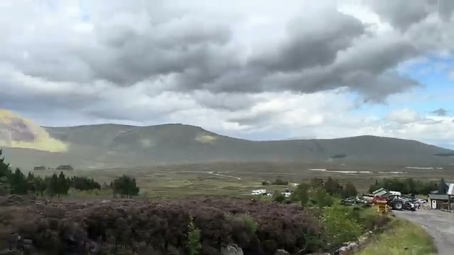 Open moorland with purple heather along the drive