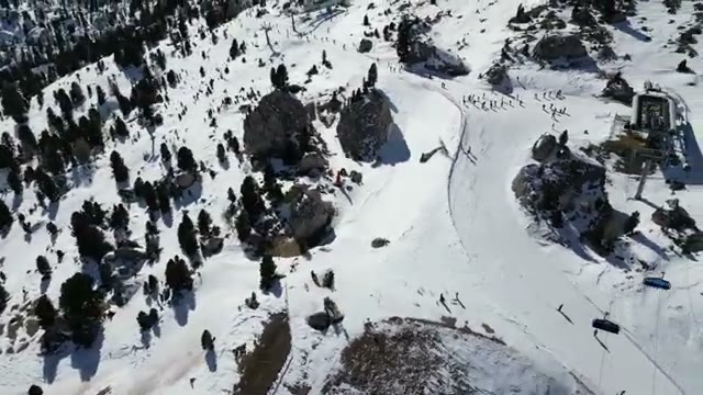 Aerial view of the pistes, lifts, and rock outcrops
