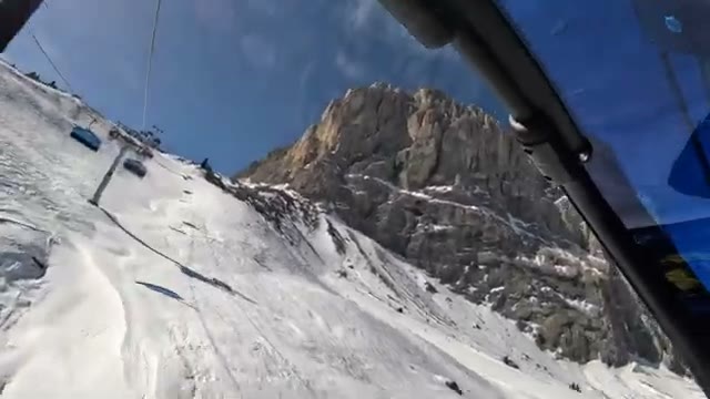Riding the chairlift up alongside the rocky cliffs