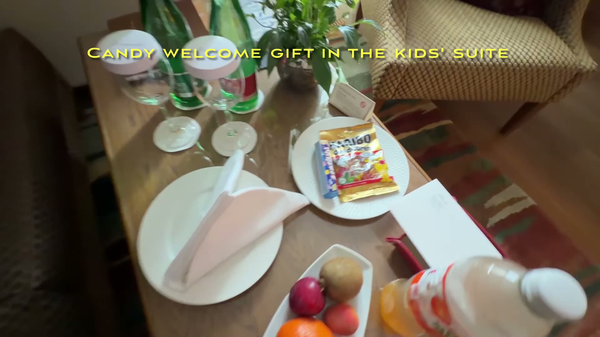 Welcome sweets, fruit and drinks arranged on the coffee table in the children’s suite