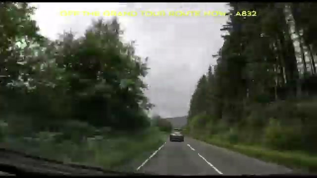 The A832 through tall conifers after leaving the Grand Tour route