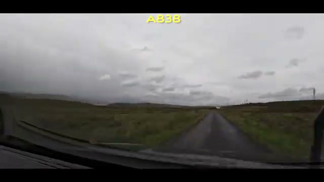 The A838 running through open moorland under a heavy grey sky