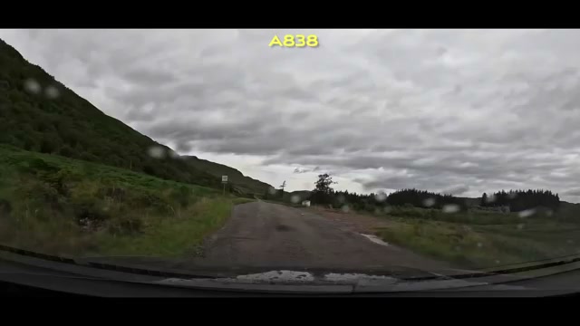 Rain on the windshield as the A838 runs through a green valley
