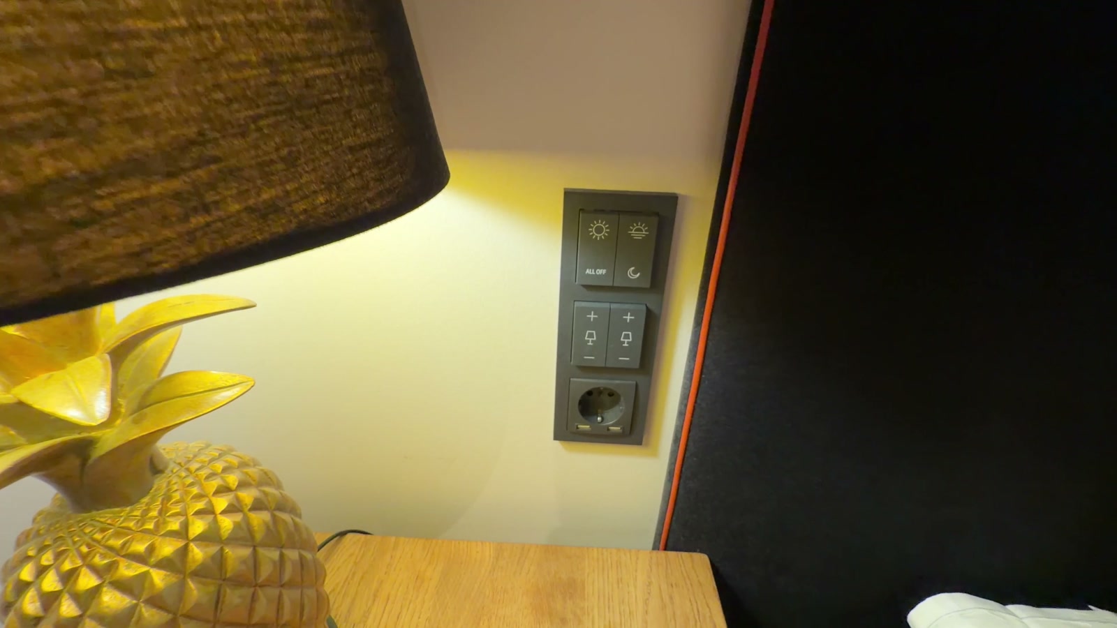 Bedside pineapple lamp next to the light controls and USB outlet