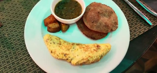Breakfast plate: omelette, puri, and chutney