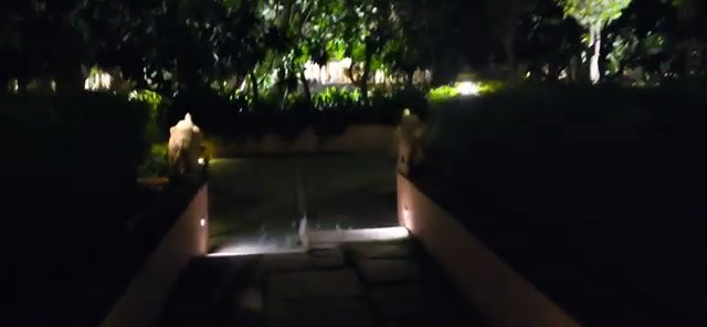 Lit walkways through the villa grounds at night