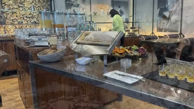 Breakfast buffet spread with juices, breads, and fresh fruit