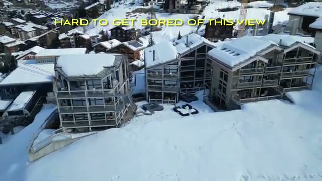 Terrace view over snow-covered Zermatt village rooftops