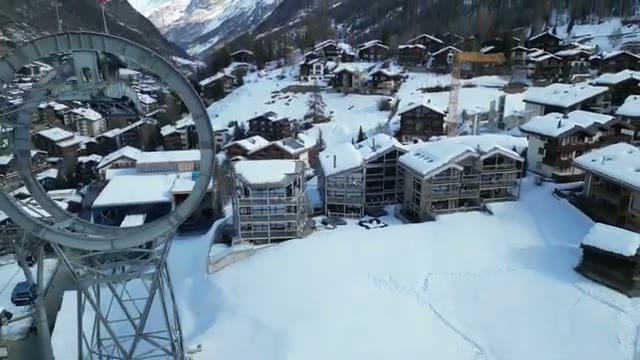 View of snow-covered Zermatt rooftops and the gondola tower near the hotel