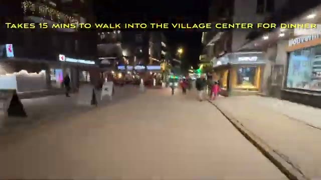 Zermatt village street at night with lit shopfronts
