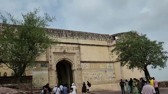 The frescoed entrance gate with visitors