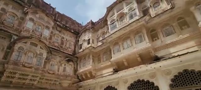 The palace courtyardβs carved facades and balconies