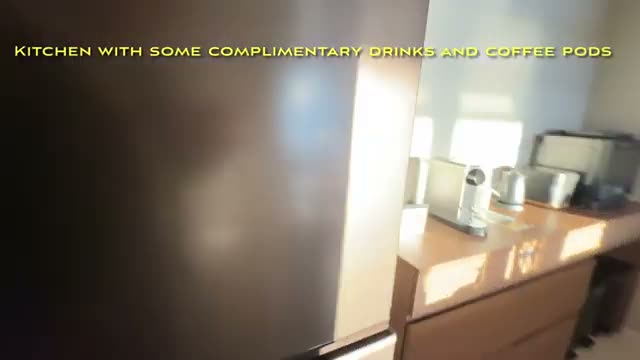 The kitchen, stocked with complimentary drinks and coffee pods