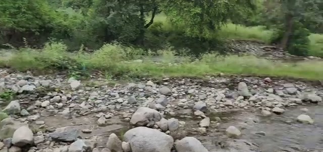 The rocky Magai riverbed near the temple