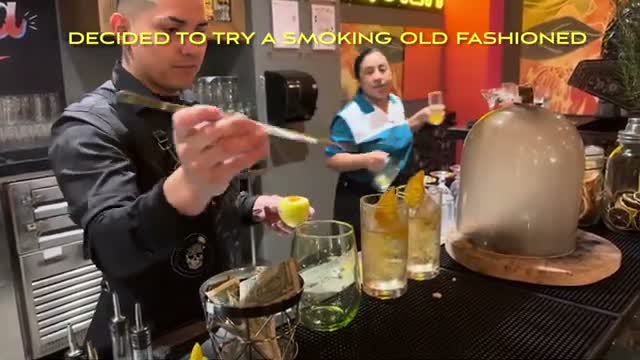 A smoking old fashioned at the bar