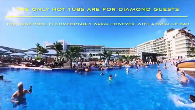 The huge main pool, comfortably warm, with a swim-up bar