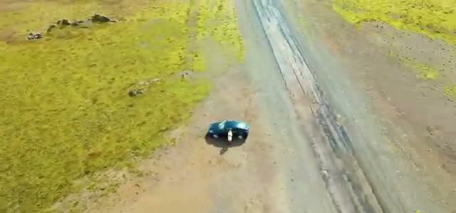 The Model Y on a gravel road during the Rt 208/209 detour, from the drone