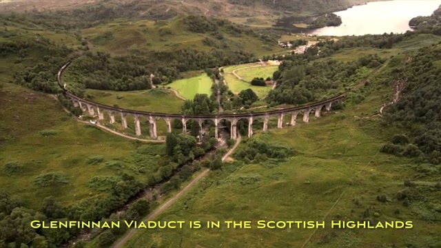 The Glenfinnan Viaduct curving through the Scottish Highlands, seen from the air