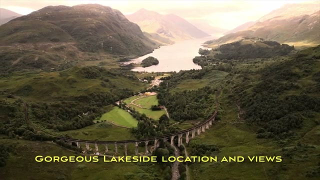 The viaduct in its lakeside setting with Highland mountains behind